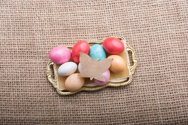 Paper Butterfly on Colorful candy sweets in tray