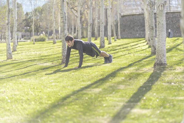 Man doing push ups in the park