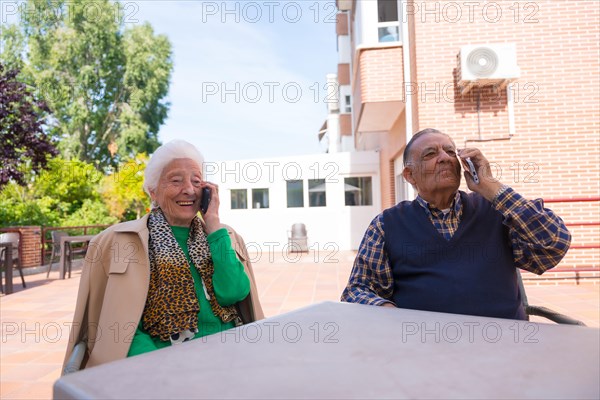 Two elderly people in the garden of a nursing home