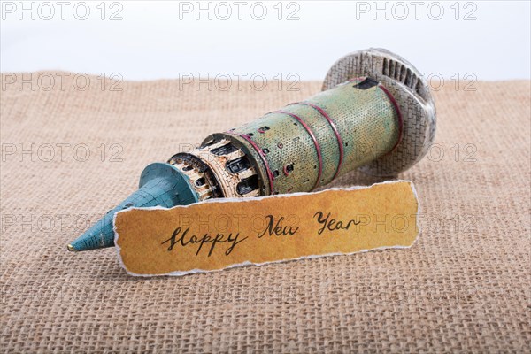 Happy new year written torn paper on Galata Tower model