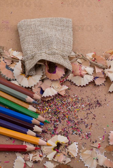 Colorful pencil shavings coming out of sack