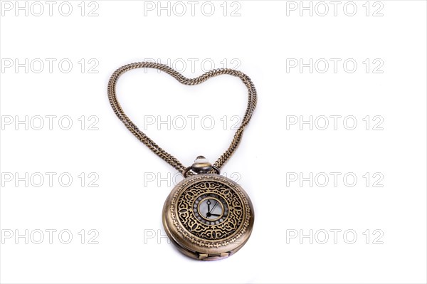 Retro styled pocket watch and its chain form a heart on a white background