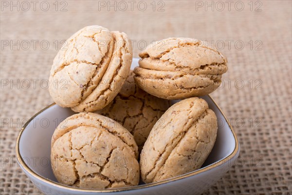 Turkish almond cookies in a plate on a linen canvas