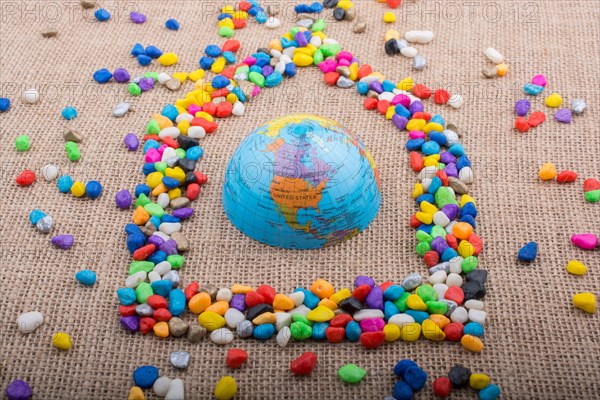 Globe in the house form shaped by colorful pebbles