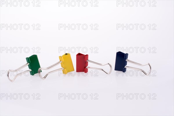 Colored paper clips on a white background