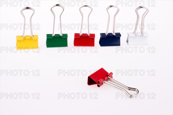 Colored paper clips on a white background