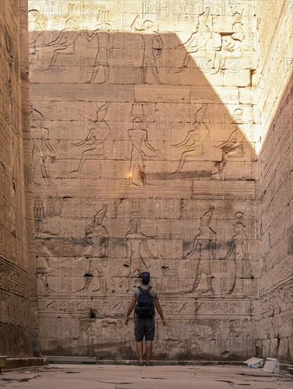 A young tourist visiting the beautiful temple of Edfu in the city of Edfu