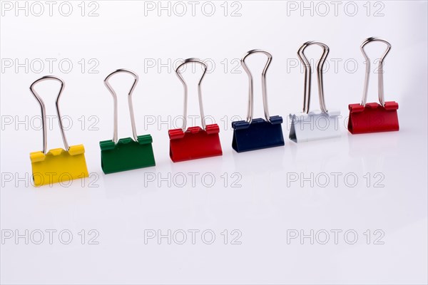 Colored paper clips on a white background