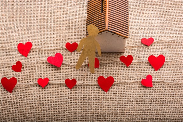 Heart shaped icons and paper house on linen threads