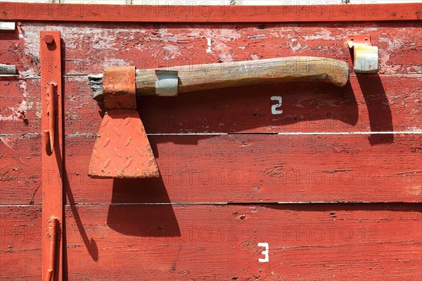 Red axe on red background