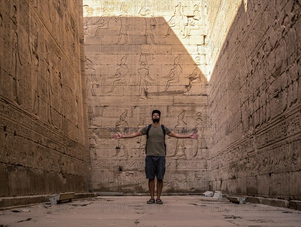 A young tourist visiting the beautiful temple of Edfu in the city of Edfu