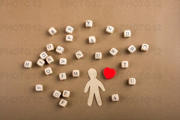 Letter cubes of made of wood and man figurine and heart shape