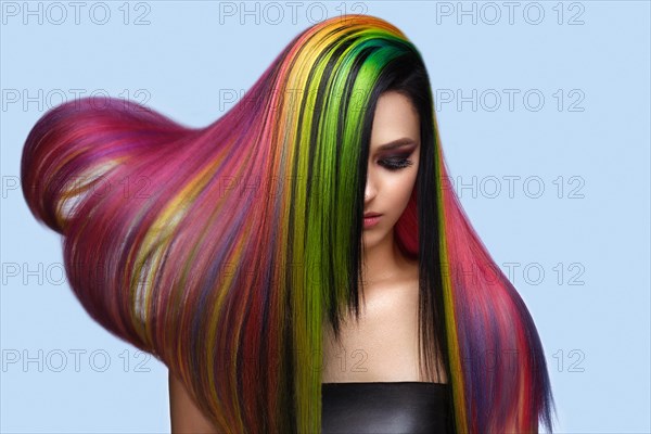 Portrait of beautiful woman with multi-colored hair and creative make up and hairstyle