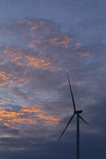 Wind power plant in front of evening sky