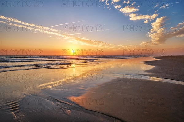 Atlantic ocean sunset with surging waves at Fonte da Telha beach