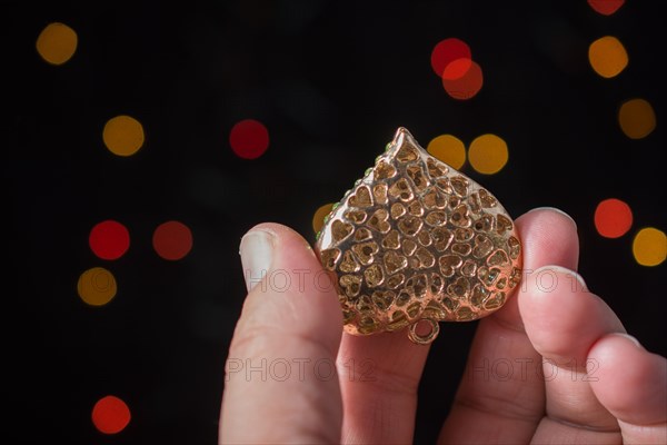 Heart shape icon in hand on bokeh light