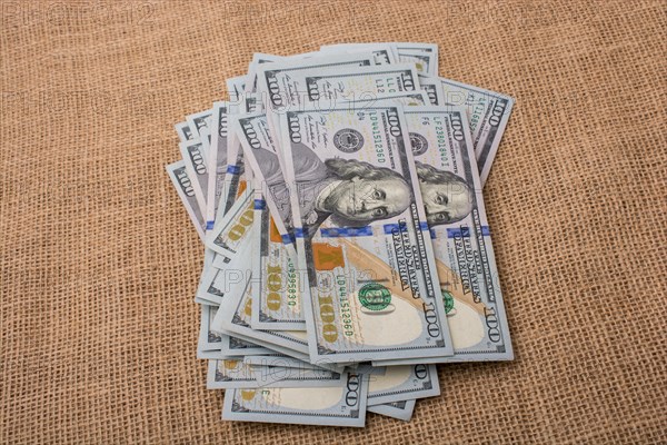 Banknote bundle of US dollar placed on a linen canvas