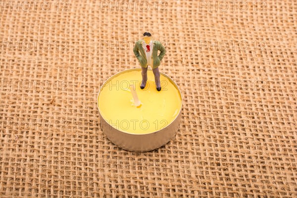 Figurine man standing on a linen canvas