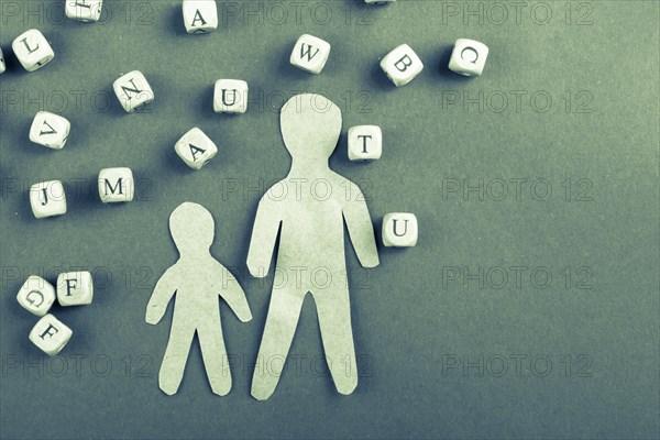 Letter cubes of made of wood and men figurine