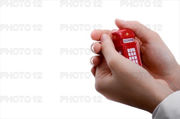 Telephone booth in hand on a white background