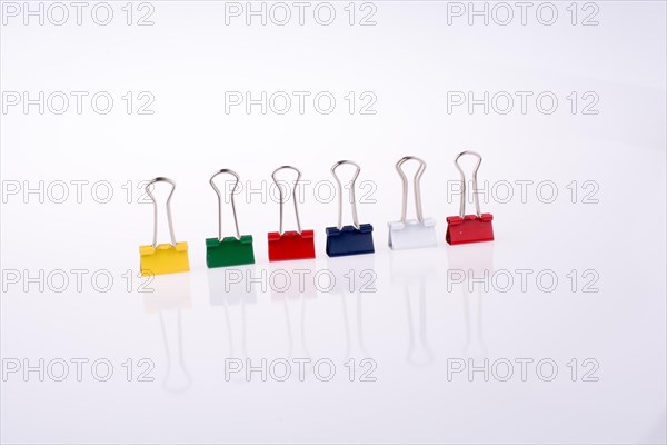 Colored paper clips on a white background