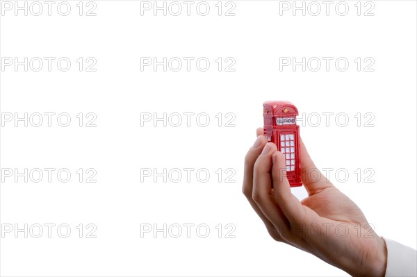 Telephone booth in hand on a white background