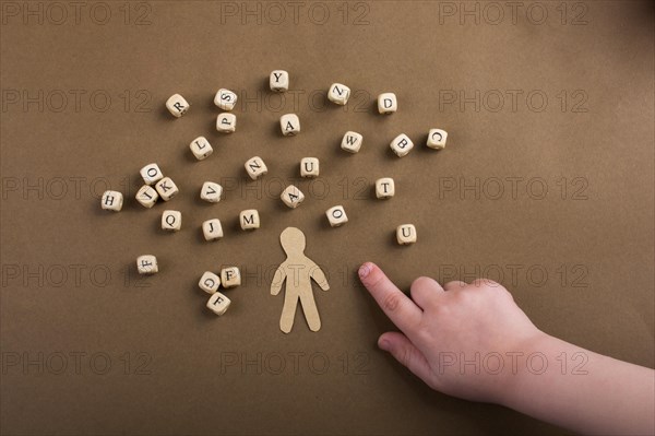 Letter cubes of made of wood and man figurine