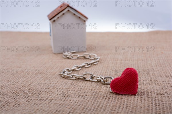 Model house and chain with a heart on canvas