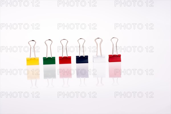 Colored paper clips on a white background