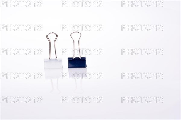 Colored paper clips on a white background