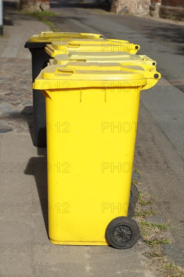 Yellow bins for plastic waste standing on the street