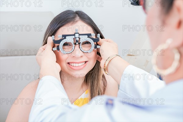 Vision check with optometrist trial frame on patient. Doctor checking vision of patient with trial frame in ophthalmology clinic