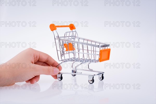 Hand holding a Cart on a white background