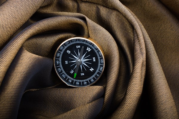 Black color compass instrument on fabric canvas