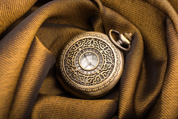 Mechanical retro styled pocket watch on fabric