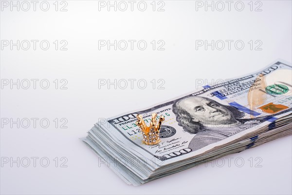 American 100 dollar banknotes and a gold color crown