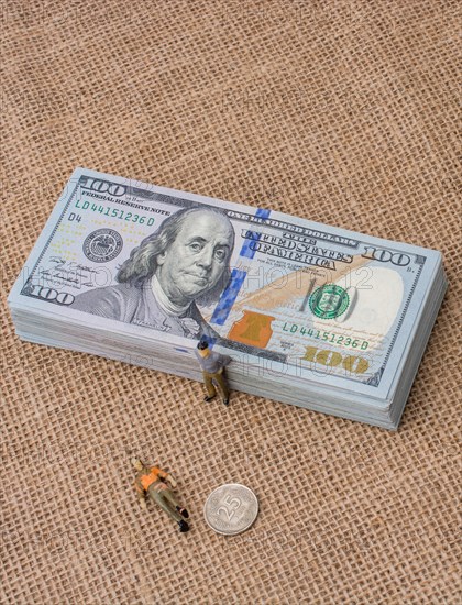 Men figurines found beside the bundle of US dollar banknote