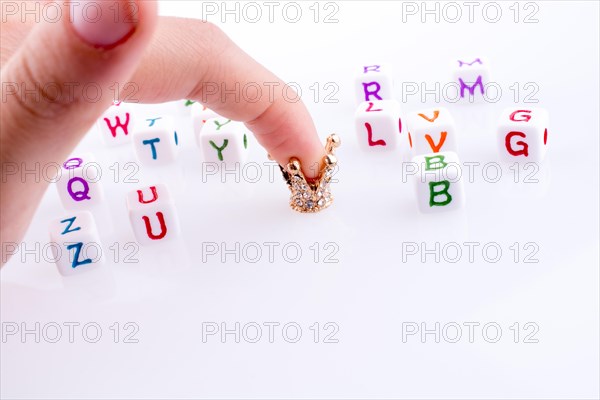 Crown between Letter cubes on a white background