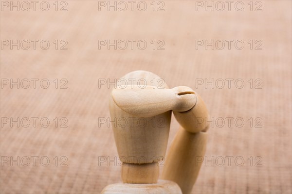 Wooden dolls of a man posing on canvas