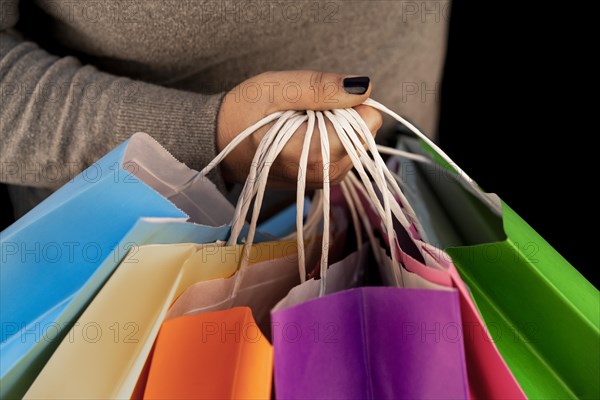 Shopping bags in the woman hands. Joy of consumption. Purchases