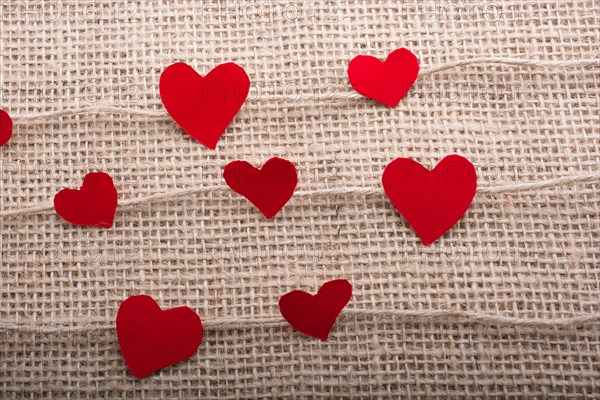 Love concept with heart shaped papers on linen threads