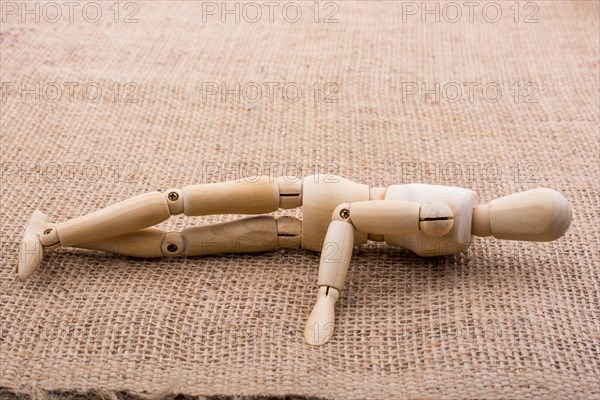 Wooden dolls of a man posing on canvas