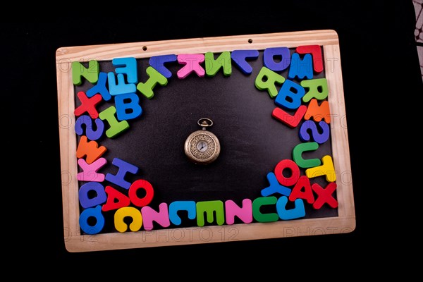 Pocket watch and colorful Letters of Alphabet made of wood