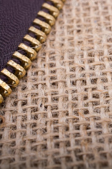 Closeup of a colorful zipper on linen canvas