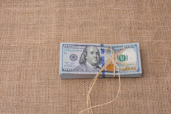 Banknote bundle of US dollar tied with colorful a ribbon