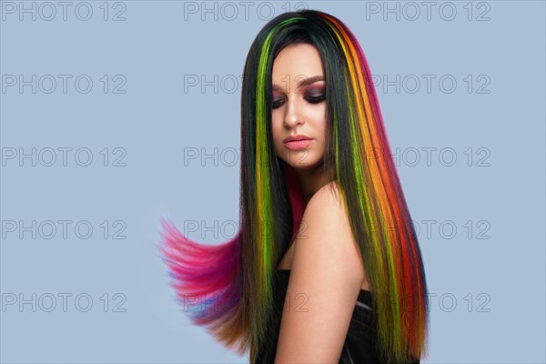 Portrait of beautiful woman with multi-colored hair and creative make up and hairstyle