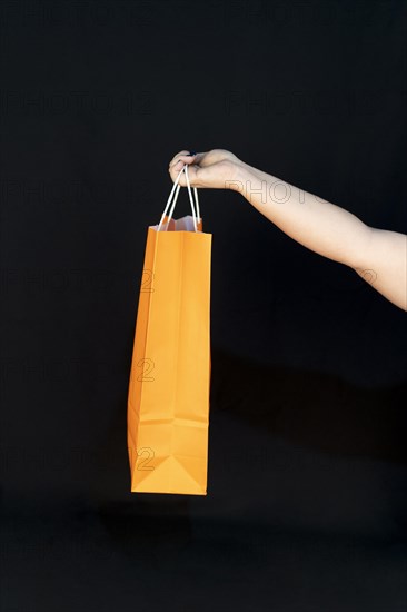 Shopping bag in the woman hands. Joy of consumption. Purchases