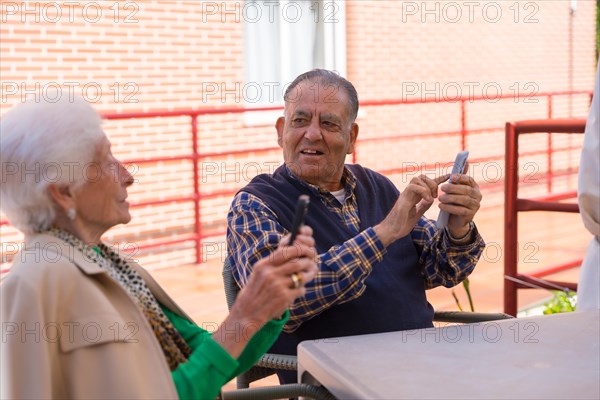 Two very happy elderly people in the garden of a nursing home