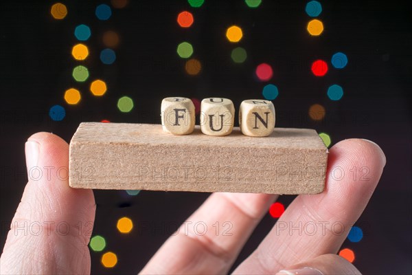 Fun wording in hand cubes bokeh lighton a dark background