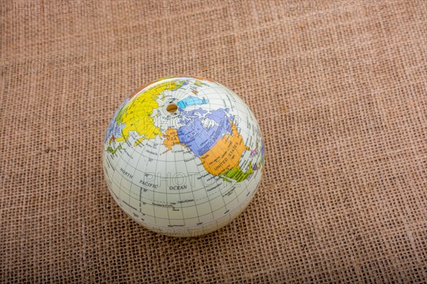 Globe placed on a brown fabric background